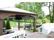 Outdoor area featuring an entertainment space with a grill, stone firepit, and playground in the background at 10113 Gallop Ln, Fortville, IN 46040