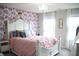Charming bedroom with floral wallpaper, pink bedding, and a decorative canopy bed at 10113 Gallop Ln, Fortville, IN 46040