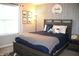 bedroom featuring blue and white patterned wallpaper, a gray bed, and modern decor at 10113 Gallop Ln, Fortville, IN 46040