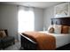 Neutral bedroom showcases an upholstered bed, fluffy pillows, and soft natural light at 10113 Gallop Ln, Fortville, IN 46040