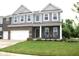 Inviting two-story home showcasing a brick facade, well-kept lawn, and a welcoming front porch at 10113 Gallop Ln, Fortville, IN 46040