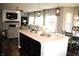 Open kitchen featuring a large island with pendant lighting and sightlines to living and dining spaces at 10113 Gallop Ln, Fortville, IN 46040
