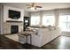 Cozy living room with fireplace, large sectional sofa, and plenty of natural light from the windows at 10113 Gallop Ln, Fortville, IN 46040