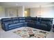 A cozy living room showcases a large blue sectional and colorful rug, perfect for lounging at 10113 Gallop Ln, Fortville, IN 46040