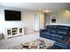 Upstairs living room offers a comfy blue couch, TV, and neutral walls for a relaxing atmosphere at 10113 Gallop Ln, Fortville, IN 46040
