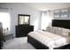 Spacious main bedroom with a dark wood dresser, neutral color palette, and ample natural light at 10113 Gallop Ln, Fortville, IN 46040
