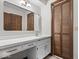 Bathroom featuring a vanity, mirror, and wood-paneled closet at 110 Leichester Ct, Noblesville, IN 46060