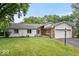 Charming single-story home with a well-manicured lawn and attached two-car garage and brick and vinyl siding at 110 Leichester Ct, Noblesville, IN 46060