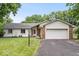 Charming single-story home with a well-manicured lawn and attached two-car garage and brick and vinyl siding at 110 Leichester Ct, Noblesville, IN 46060