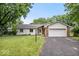 Charming single-story home with a well-manicured lawn and attached two-car garage and brick and vinyl siding at 110 Leichester Ct, Noblesville, IN 46060