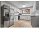 Well-lit kitchen showcasing white cabinets, stainless steel appliances, and granite countertops at 110 Leichester Ct, Noblesville, IN 46060