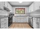 Well-lit kitchen featuring white cabinets, stainless steel appliances, granite countertops, and wood-look flooring at 110 Leichester Ct, Noblesville, IN 46060