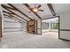 Large living room featuring exposed wood beams, brick fireplace, and seamless transition to sunroom at 110 Leichester Ct, Noblesville, IN 46060