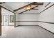 Spacious living room boasting vaulted ceilings, exposed wood beams, and seamless access to sunroom at 110 Leichester Ct, Noblesville, IN 46060