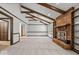 Bright living room features vaulted ceilings with exposed wood beams, a cozy brick fireplace, and carpeted floors at 110 Leichester Ct, Noblesville, IN 46060