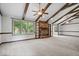 Spacious living room features vaulted ceilings with exposed wood beams, a brick fireplace, and large windows at 110 Leichester Ct, Noblesville, IN 46060