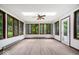 Bright sunroom with wood trim windows, skylight, and a door leading outside at 110 Leichester Ct, Noblesville, IN 46060
