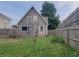 Large backyard with privacy fence, patio and red door, with ample space for outdoor activities at 121 N Main St, Pendleton, IN 46064