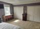 Bedroom featuring carpet, natural light, and ample closet space at 121 N Main St, Pendleton, IN 46064