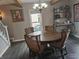 Bright dining area with a chandelier, stylish furnishings, and adjacent living room at 121 N Main St, Pendleton, IN 46064