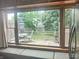 Kitchen view through a large window to outdoor living area and backyard at 121 N Main St, Pendleton, IN 46064