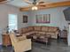 Cozy living room with a comfortable sofa, accent chair, and exposed beam at 121 N Main St, Pendleton, IN 46064