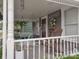 Inviting front porch with swing, rocking chairs and decorative wreath at 121 N Main St, Pendleton, IN 46064