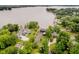 Expansive aerial view showcasing a lakefront estate surrounded by lush landscaping at 121 Wesley Cir, Noblesville, IN 46062