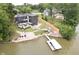 An aerial view of the home shows multiple decks, lake access, and professional landscaping at 121 Wesley Cir, Noblesville, IN 46062