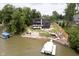 An aerial view of the home shows the many decks, landscaping, and boat dock on the lake at 121 Wesley Cir, Noblesville, IN 46062
