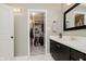 Bathroom featuring a vanity with black cabinetry, a white countertop, a mirror, and an open closet with shelving at 121 Wesley Cir, Noblesville, IN 46062