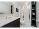 Bathroom features a shower, black vanity, and a large wall mirror at 121 Wesley Cir, Noblesville, IN 46062