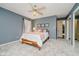 Bedroom with a wooden bed frame, light-colored walls, and a doorway leading to another room at 121 Wesley Cir, Noblesville, IN 46062