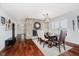 Well-lit dining room with fireplace, hardwood floors, and large windows providing natural light at 121 Wesley Cir, Noblesville, IN 46062