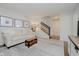 Comfortable living room with a decorative rug, white couch, and wood staircase at 121 Wesley Cir, Noblesville, IN 46062
