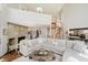 Living room with stone fireplace, spiral staircase, and cozy sectional sofa at 121 Wesley Cir, Noblesville, IN 46062