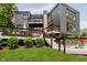 Back view of home with a stone chimney, balconies, and a multi-level deck at 121 Wesley Cir, Noblesville, IN 46062