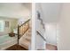 View of a carpeted staircase with wood handrail, leading into the living room at 121 Wesley Cir, Noblesville, IN 46062