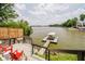 Lake view from a deck with red chairs and a railing at 121 Wesley Cir, Noblesville, IN 46062