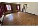 Spacious living room with hardwood floors, multiple windows, and a bright, inviting atmosphere at 1227 W 9Th St, Anderson, IN 46016