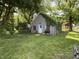 Outdoor shed covered in foliage on a grassy lot, providing storage space or potential project area at 1227 W 9Th St, Anderson, IN 46016
