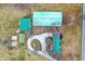 Directly above, the property showcases buildings with green roofs, including a large barn, interconnected by a winding driveway at 12471 N 100 E, Alexandria, IN 46001