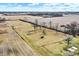 Expansive property featuring a weathered shed in a grassy clearing surrounded by harvested fields and distant trees at 12471 N 100 E, Alexandria, IN 46001