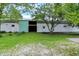 Barn with white siding and an open sliding door on well-maintained lawn at 12471 N 100 E, Alexandria, IN 46001