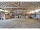 Open barn interior showcasing the exposed beam ceiling with natural lighting and ample storage space at 12471 N 100 E, Alexandria, IN 46001