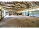 Expansive barn interior featuring an exposed beam ceiling with natural lighting and an open layout at 12471 N 100 E, Alexandria, IN 46001