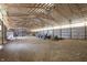 Large barn interior featuring an exposed beam ceiling with lighting, cars, tractors and storage at 12471 N 100 E, Alexandria, IN 46001