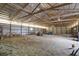 Expansive barn interior with an exposed beam ceiling with lighting, and ample open space and storage at 12471 N 100 E, Alexandria, IN 46001