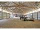 Vast barn interior with an exposed beam ceiling, natural lighting, tractor and equipment storage at 12471 N 100 E, Alexandria, IN 46001