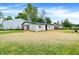 A well-kept property featuring multiple barns and outbuildings surrounded by well-maintained grass at 12471 N 100 E, Alexandria, IN 46001